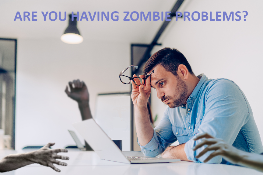 Image of man at desk in office poring over some work while some eerie and sinister hands are reaching over the desk to disrupt him.